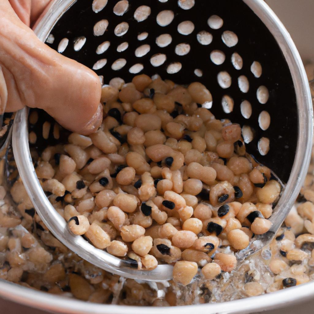 Draining and rinsing soaked black eyed peas to remove excess starch