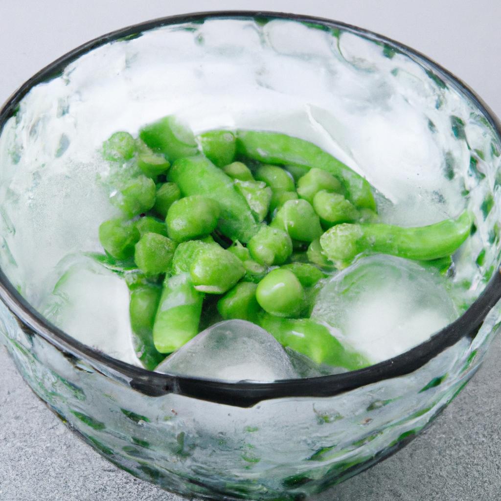 Quickly cooling blanched snow peas in ice water helps retain their bright green color