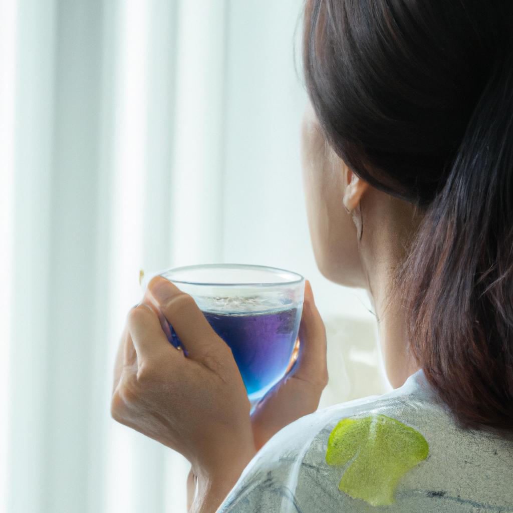 Enjoying a peaceful moment with a mug of butterfly pea tea - a natural way to promote weight loss